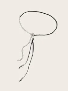 Detailed view of fashionable metal and leather braided waist chain with chic pendant charms.