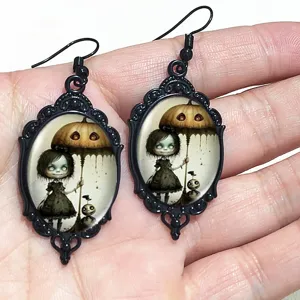 Gothic Halloween black oval earrings featuring eerie cute girl and pumpkin umbrella print.
