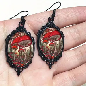 Gothic black oval drop earrings featuring a fantasy red mushroom forest art print design.