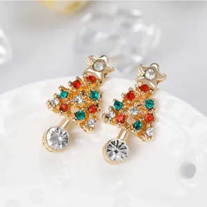 Detailed close-up of Christmas tree rhinestone earrings, sparkling festive holiday stud design.