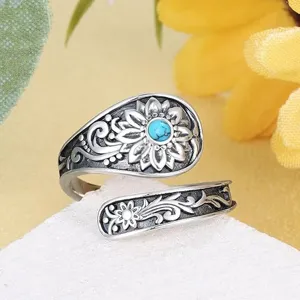 Detail shot of retro bohemian adjustable ring with sunflower and turquoise stone accent.