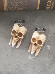 Gothic Halloween handmade skull tooth earrings, punk style dark horror jewelry detail view.