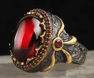 Vintage red cabochon ring with dual-tone black gold plating and intricate carved details.