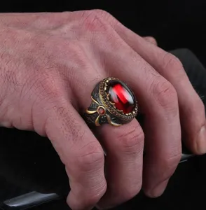 Vintage style men ring with red glass gemstone, two-tone gunblack and gold plating detail.