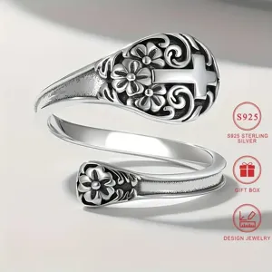 Close-up details of the vintage silver spoon ring featuring floral and cross engravings.