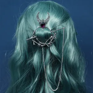 Detail view of gothic witch crescent moon hair stick with purple crystal and chain.