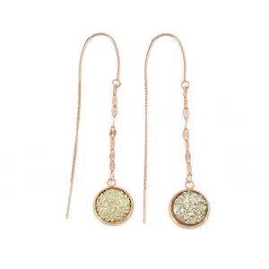 Close-up of rose gold long chain earrings featuring sparkling druzy round stone pendants for elegant style.