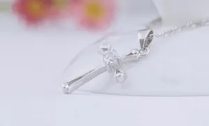Elegant silver cross pendant necklace with sparkling cubic zirconia stone minimalist design