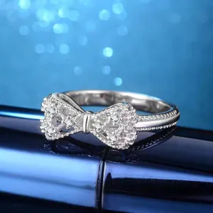 Close-up detail shot of a sparkling cubic zirconia bowknot ring, elegant jewelry piece.