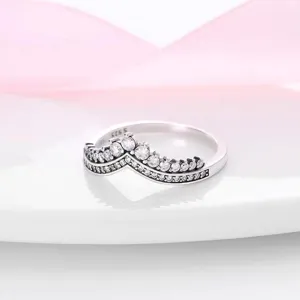Close up detail of sparkling silver crown V-shaped ring with dazzling zircon stones.
