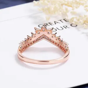 Close-up detail of a rose gold crown wishbone ring inlaid with sparkling cubic zirconia.