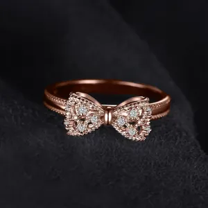 Detail shot of rose gold copper bowknot ring with sparkling cubic zirconia crystals for women.