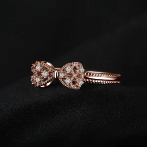 Detailed shot of a rose gold copper cubic zirconia bow ring, elegant and sweet design.