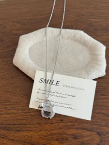 Silver-colored necklace with faceted crystal pendant on display card for women daily wear.