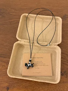 Korean fashion polka dot puppy pendant necklace with adjustable black cord for women.