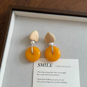 Chic wooden heart and orange ring drop earrings, unique statement fashion jewelry for women.