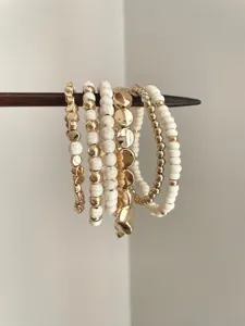 Bohemian multi-layer beaded bracelet set with white stone and gold metal accents for women.