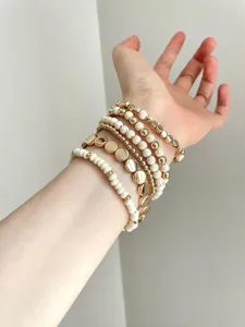 Boho multi-layer stacked beaded bracelets for women, featuring gold disc and white stone charms.