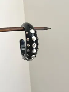 Glossy black chunky C-shaped hoop earring accented with silver studs for daily wear.