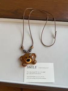 Korean ins style 3D acrylic brown bear pendant necklace with retro beads and leather cord accessory.