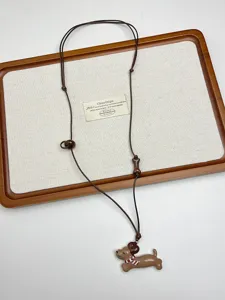 Cute puppy pendant and adjustable wooden bead on this chic Korean style brown cord necklace.