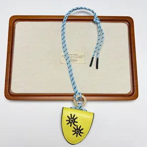 Leather sunglasses holder necklace lanyard, stylish yellow shield pouch with blue cord.