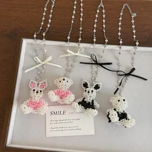 Cute pearl beaded rabbit necklace with bow, long sweater chain, stylish jewelry accessory.