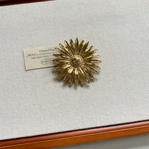 Vintage style metal sunflower brooch for women, elegant gold flower pin fashion accessories.