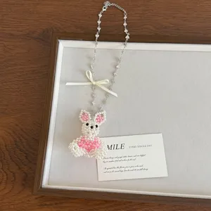 Charming pearl beaded rabbit necklace detail showing cute pink bow and delicate heart chain.