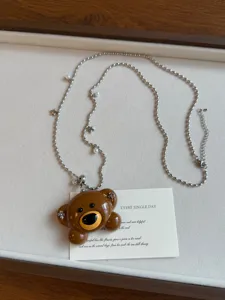 Cute brown bear pendant necklace with pearl and star bead chain, fashion accessories.