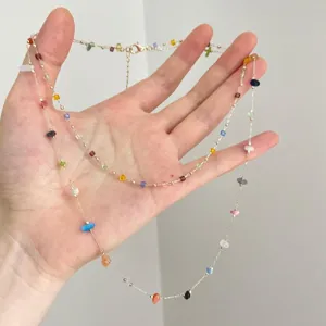 Colorful irregular stone beaded delicate clavicle necklace close-up jewelry detail display item.