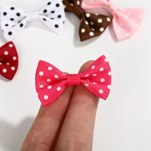 Close-up of a pink polka dot grosgrain ribbon bow accessory for DIY crafts and hair decor