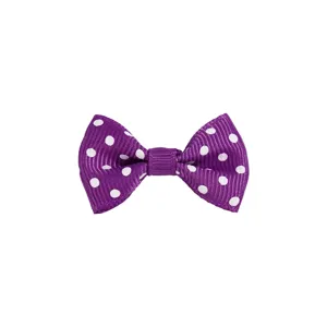 Detailed view of a purple grosgrain ribbon bow with white polka dots for DIY crafts