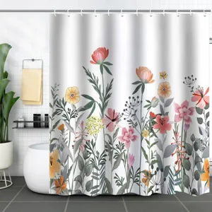 Waterproof floral shower curtain hanging in a bright and modern bathroom setting.