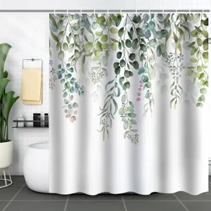 Detail view of a waterproof white shower curtain with green eucalyptus leaf print.