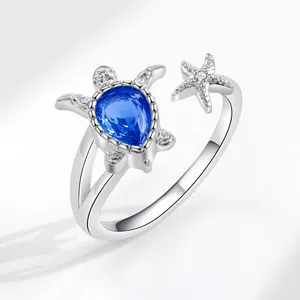 Silver open ring featuring a cute turtle with blue stone and starfish design for summer beach.