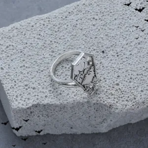 Close-up detail of vintage punk gothic skull moon sun ring gothic jewelry decor surface texture.