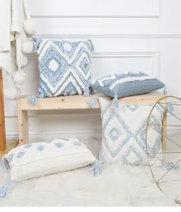 Detailed view of Scandinavian blue geometric tufted throw pillow covers with elegant tassels.