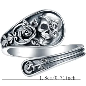 Close-up detail of retro gothic skull and rose open ring with intricate floral relief.