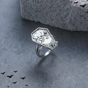 Close-up detail of the vintage punk coffin ring featuring intricate skull and face carving.