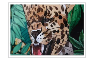 Close-up detail of tropical jungle leopard print cushion cover with watercolor style.