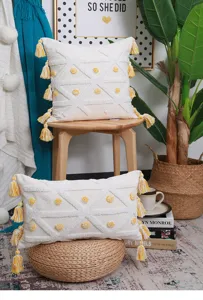 Nordic tufted throw pillow cover with geometric pattern and yellow tassels for home decor.