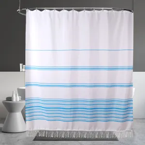 Modern minimalist white and blue striped shower curtain with bottom fringe for bathroom decor.