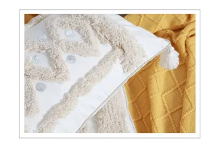 Boho tufted pillow cover detail shot featuring geometric pattern and cozy textured fabric decor.