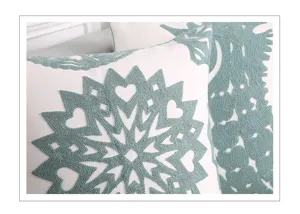 Detailed view of embroidered cotton throw pillow featuring green towel embroidery design for sofa.