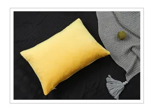 Detailed close-up shot of yellow velvet pillowcase displayed on dark textured home setup.