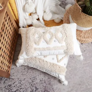 Boho tufted throw pillow cover with geometric pattern and tassels for modern sofa decor.