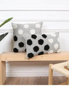 Nordic style tufted throw pillow cover detail shot showing textured black and white loop polka dots.
