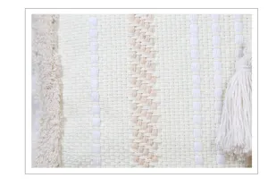 Close-up view of woven cushion cover with beige stripes, tufted texture and side tassel.