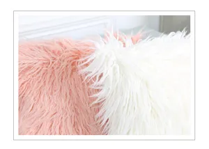 Closeup detail view of soft fluffy long faux fur pillowcase in pink and white colors.